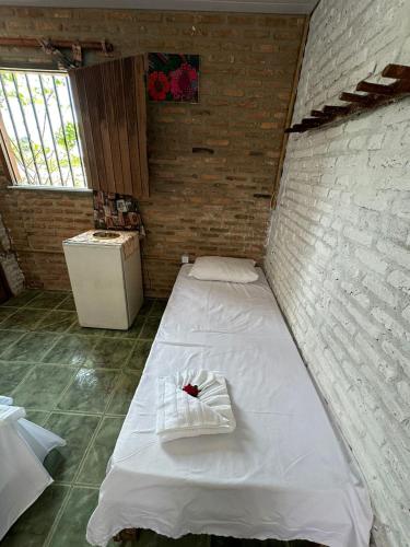 Ein Bett oder Betten in einem Zimmer der Unterkunft Pousada Sol Nascente