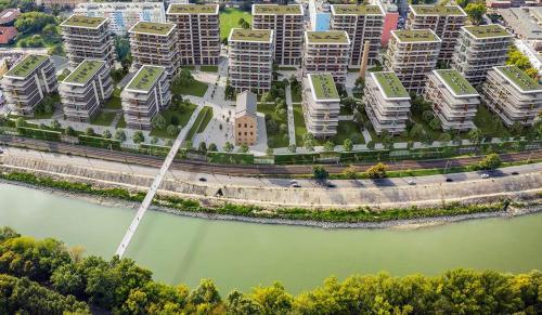 an aerial view of a city with buildings and a river at SWEET HOME Apartman , 30sqm studio, free private parking, mountain view, balcony, 20 min from downtown in Budapest