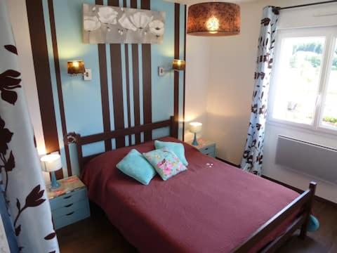 a bedroom with a red bed with two pillows on it at AB Bel appartement 1 à 4 pers face vallée 3 étoiles WIFI in Le Tholy