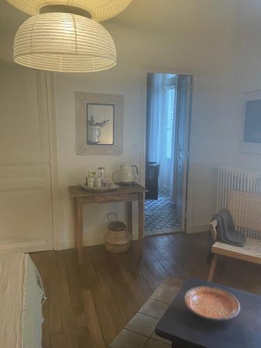 a living room with a table and a hallway at Villa Louisa in Saint Malo