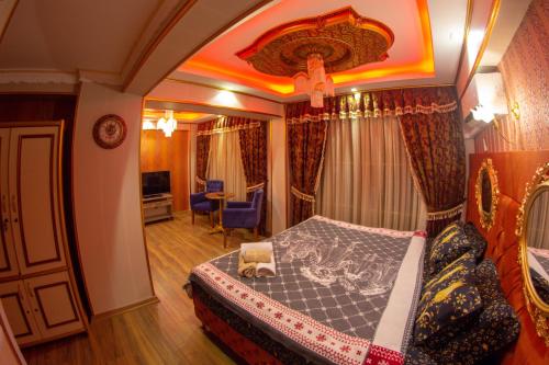a bedroom with a king sized bed in a room at Marko Paşa Konağı in Kusadası