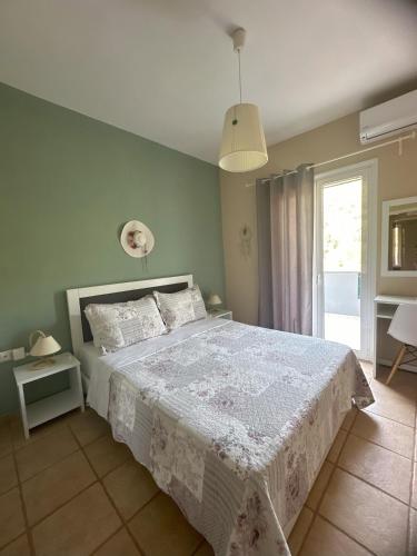a bedroom with a bed with a white bedspread at Vafkeri Apartments in Vavkerí