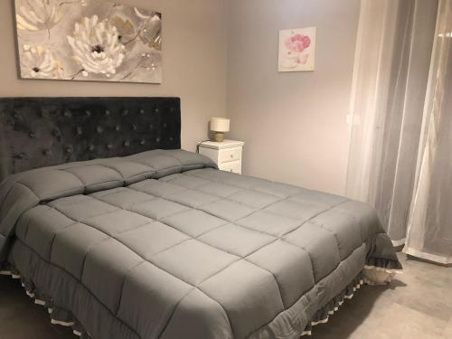a bedroom with a bed and a dresser in it at Residence l'Ogliastro in Petrizzi