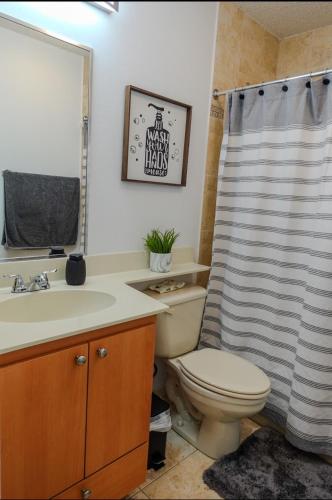 a bathroom with a toilet and a shower curtain at Close to Combate beach, el poblado and restaurants in Pole Ojea