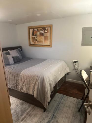 a bedroom with a bed and a picture on the wall at Your Home away from Home ! in Baychester