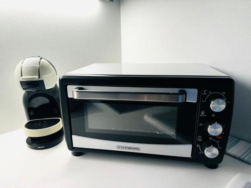 a black and white microwave sitting on a counter at Ferienwohnung Schönblick in Sankt Englmar
