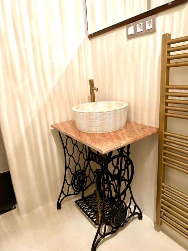 a bathroom with a sink on a table at C'Anne Marie in Palafrugell