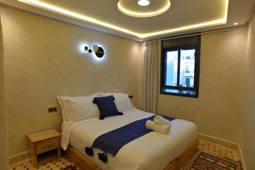 a bedroom with a bed with a teddy bear on it at Tirazir House 3 in Mirleft