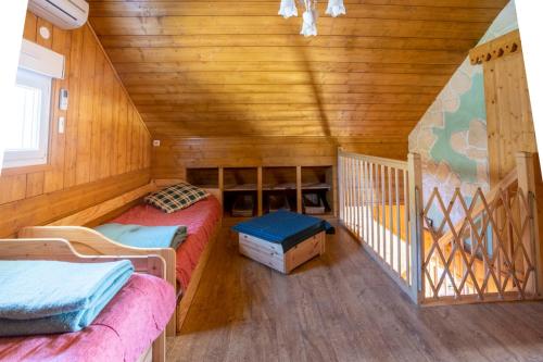 a room with two beds in a wooden cabin at AH Large apartment 1 a 7 pers 3 stars WiFi in Le Tholy