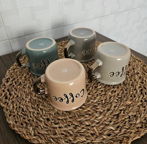 a group of four mugs sitting on a table at La Casa nel Paesello in Portocannone