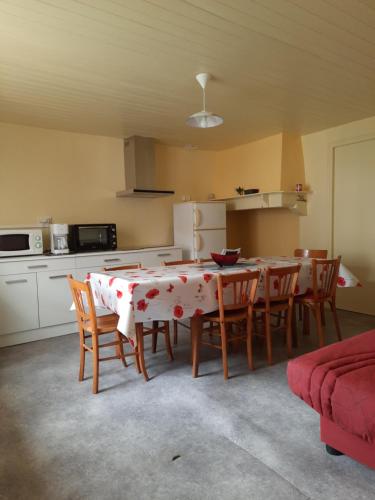 une cuisine avec une table et des chaises dans une pièce dans l'établissement La Champenoise, à Arconville