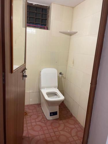 a bathroom with a toilet in a small room at Rock Hill - Pachakkad Home Stay in Athirappally