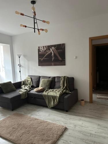 a living room with a couch and a chandelier at ARP LUXURY Apartments in Ploieşti