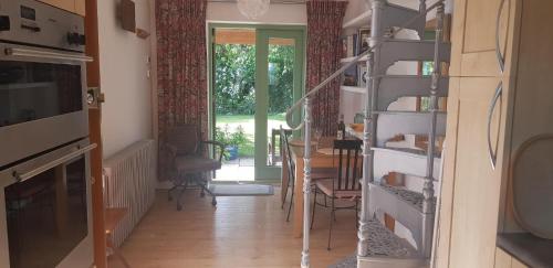 a living room with a staircase leading to a dining room at Quadrantopia in London