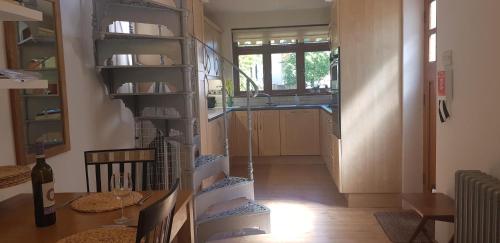 a kitchen with a spiral staircase in a room at Quadrantopia in London