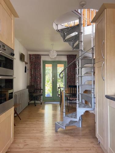 a spiral staircase in a kitchen with a table at Quadrantopia in London