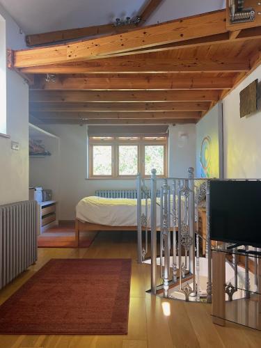 a bedroom with a bed and a television in it at Quadrantopia in London