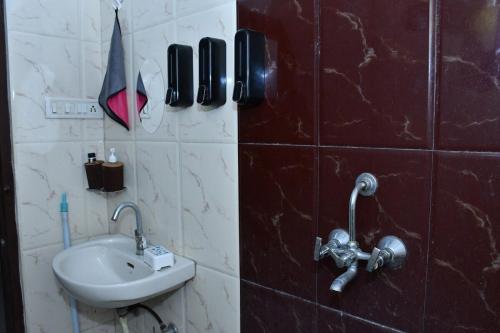 a bathroom with a sink and a phone on the wall at Independent House in Jaipur in Jaipur