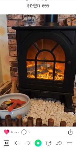 a fireplace with a plate of food in front of it at Gilson Story Pension in Pyeongchang 