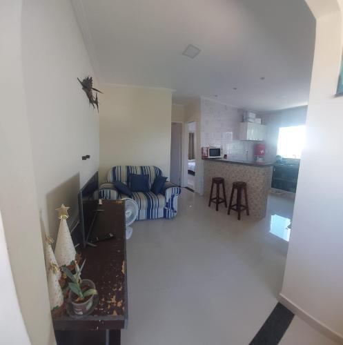 a living room with a couch and a table at Seu Segundo Lar in Valença