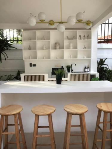 a kitchen with a white counter and stools at NEW Exclusive Luxury Pool Villa in Mactan Island