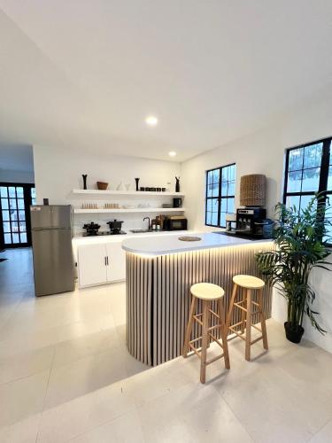 a kitchen with a counter and stools in a kitchen at NEW Exclusive Luxury Pool Villa in Mactan Island