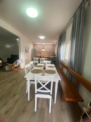 a dining room with a white table and chairs at Elegant Tuscany Mountain Villa in Momigno