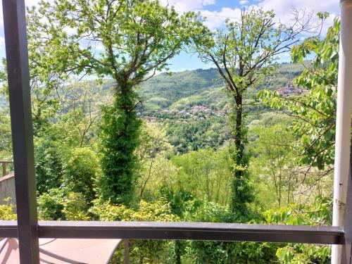 a window view of a valley from a house at Elegant Tuscany Mountain Villa in Momigno