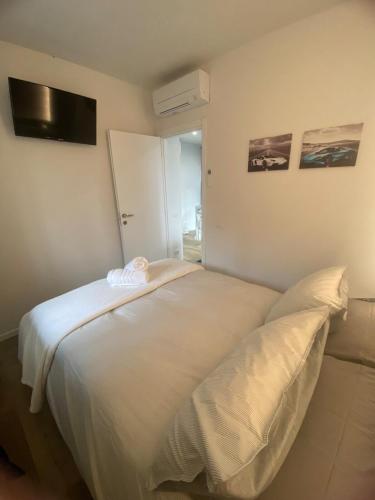 a white bed in a room with a window at Elegant Tuscany Mountain Villa in Momigno