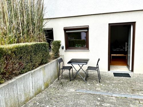 a table and two chairs in front of a house at PREMIUM HOME in Busingen am Hochrhein