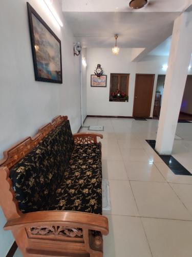 a couch sitting in a room with a white floor at Holiday home stay Puducherry in Puducherry