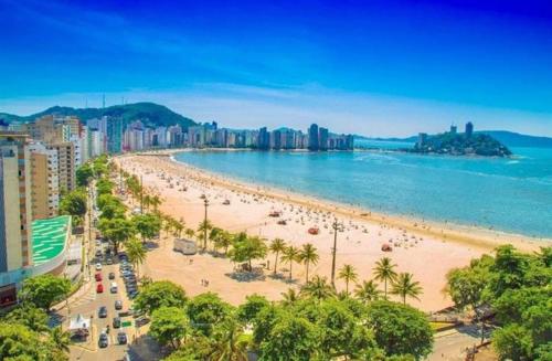 uma praia com um grupo de pessoas e o oceano em Lar de férias em São Vicente
