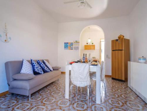 a living room with a table and a couch at Villa with Sea Views in Torre Squillace Relax in Style in Torre Squillace