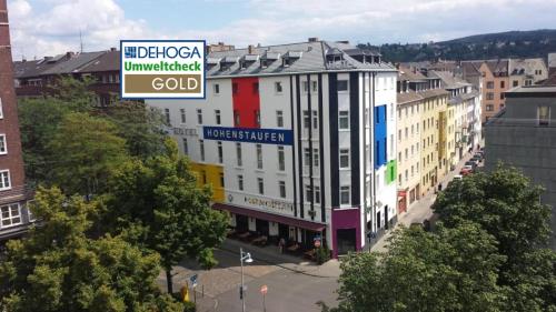a large white building with a sign on top of it at Hotel Hohenstaufen in Koblenz