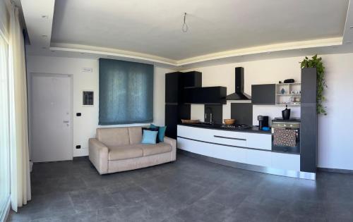 a living room with a chair and a kitchen at Villa Luigi in Valverde