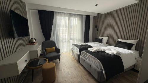 Postel nebo postele na pokoji v ubytování Sarıkamış CK Hotel
