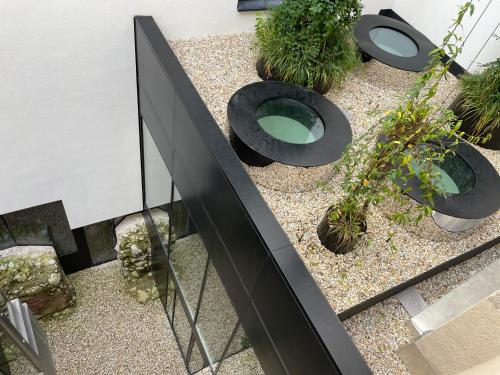 an external view of a garden with potted plants at Platzhirsch Kufstein in Kufstein
