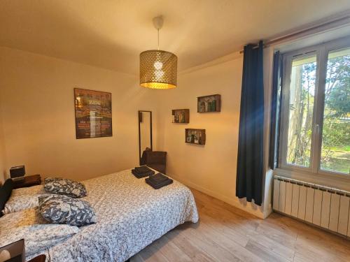 a bedroom with a bed and a window at proche centre calme jardin privé in Nantes