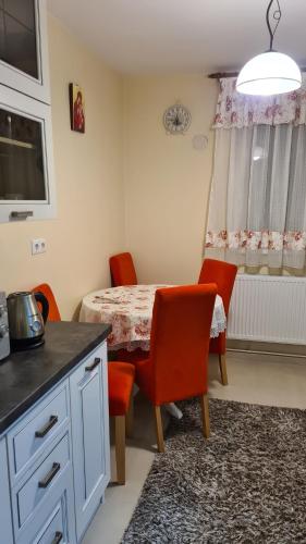 a kitchen with a table and chairs and a window at Apartament Bogdan in Gura Humorului