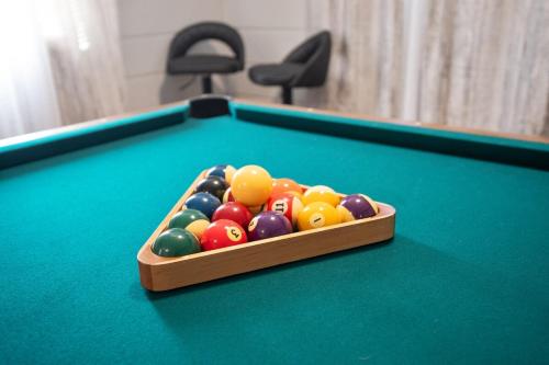 a tray of billiard balls on a pool table at Charming Retreat with Pool Table in Chesterfield! in Chesterfield