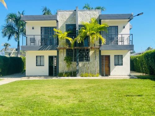 a house with a palm tree in front of it at Villas Miranda in La Tentación