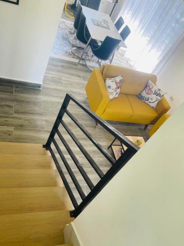 a living room with a yellow couch and a staircase at Villas Miranda in La Tentación