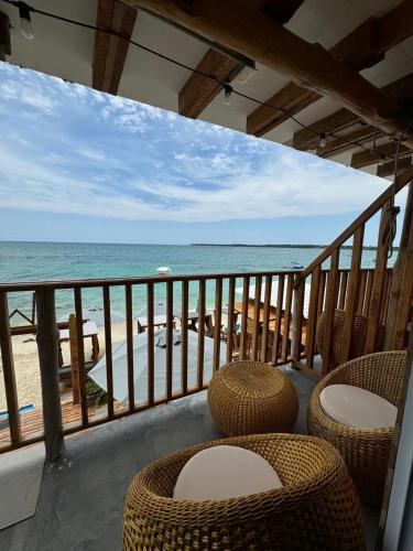 a balcony with chairs and a view of the beach at Cabañas W Beach in Cartagena de Indias