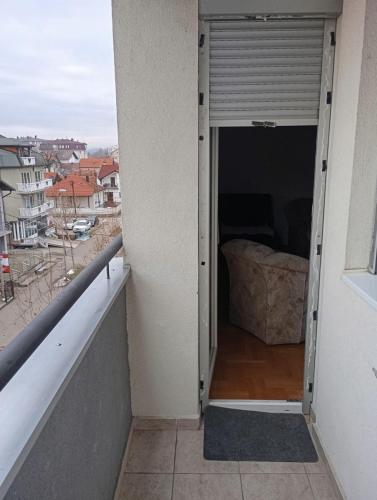 a balcony with a door open to a bedroom at Apartman kod parka in Bijeljina