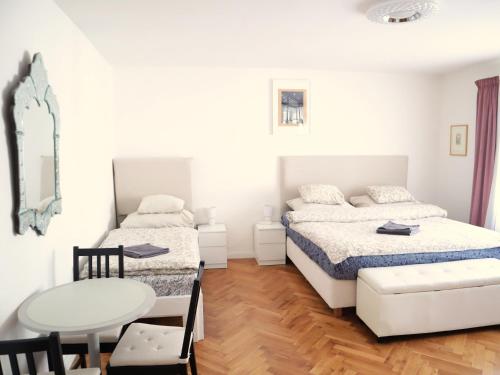 a bedroom with two beds and a table at At the Blue Lion & Parking Assistance in Prague