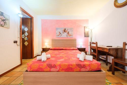 a bedroom with a bed with a desk and a desk at B&B Il Giardino Segreto in Stromboli