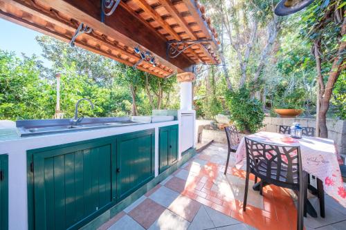 an outdoor kitchen with a sink and a table at B&B Il Giardino Segreto in Stromboli