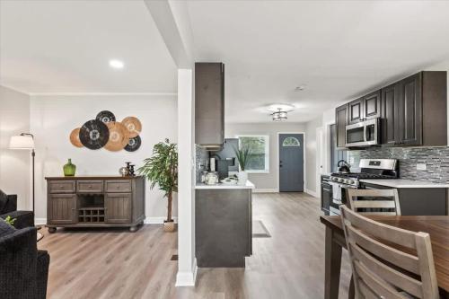 a kitchen and living room with a table and a stove at Westchester Retreat King bed in Westchester