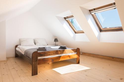 a bedroom with a bed and two windows at Charming Rustic Old Town Apartment in Krakow