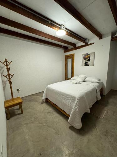 a bedroom with a large white bed in a room at Cabañas W Beach in Cartagena de Indias